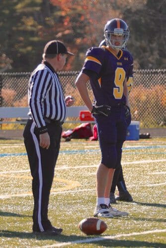 Ben on the football field with the ref